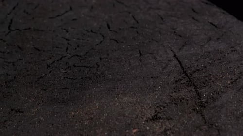 Camera flight from above, over a wooden burnt cutting board, close-up.