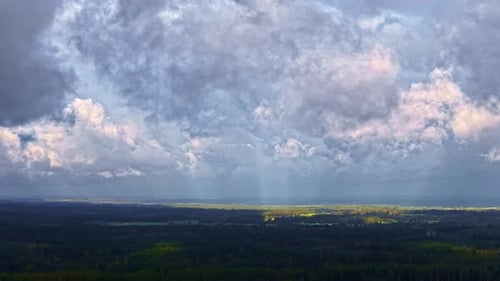 Dramatic Storm Clouds Rolling Over Wide Green Valley At Dusk