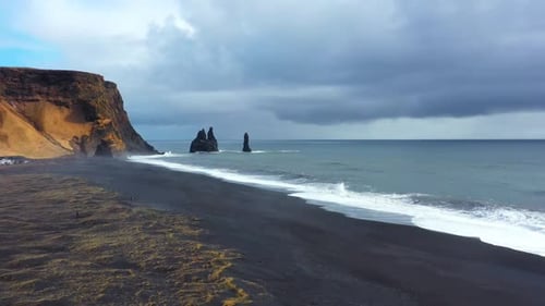 Sharp Cliffs on Black Sand Beach Reynisfjara Waves Hitting the Shore Vik Iceland