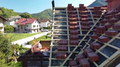 Process repair or replace shingle roof that has been damaged and needing replacement. drone view.