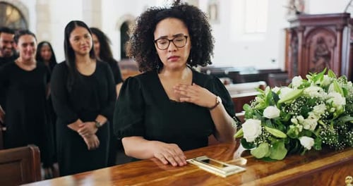 Coffin, funeral and sad woman with death, mourning and people at burial ceremony in church