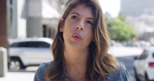 4k video footage of a young woman being interviewed about travel destinations on the street