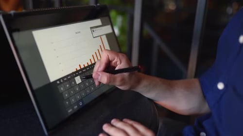Man Analyzing Business Data on Laptop Tablet Device