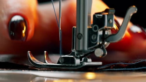 Closeup in a Sewing Workshop on a Machine the Seamstress Master Makes a Cut on Black Fabric