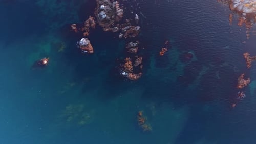 Aerial View of Rocky Coastline and Turquoise Ocean Water