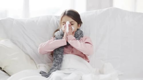 Sick Girl Sniffling with Tissue