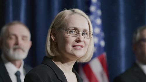 Professional Woman Giving Political Speech Near American Flag