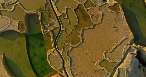 Aerial View of Xwejni Salt Pans Expansive Salt Pans Alongside a Historic Structure Natural Beauty
