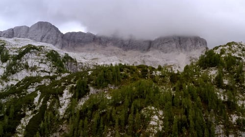 drone panorama of some peak of the alps mountains covered by clouds