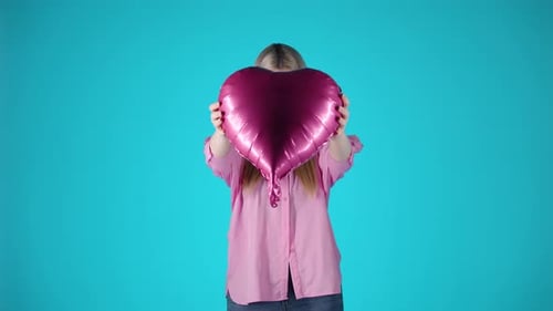 Blonde Woman Holding Hugging Heart Shaped Purple Balloon, Valentine's Mood, Studio Shot