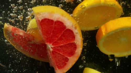 Citrus Fruit Slices Falling in Water