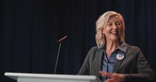 Woman Speaking Behind Podium at Event
