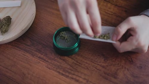 Hands Rolling Item on Table