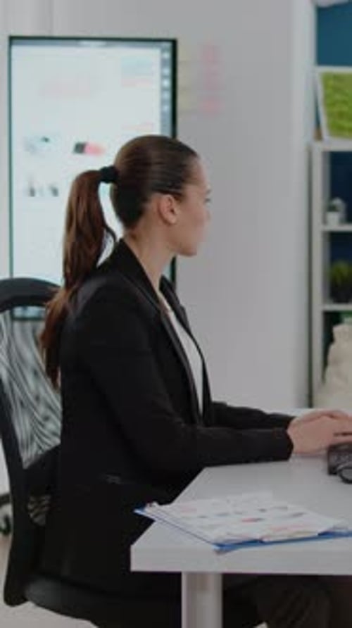 Woman Works on Computer in Modern Office