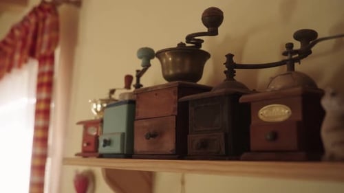Vintage Coffee Grinders on Wooden Shelf