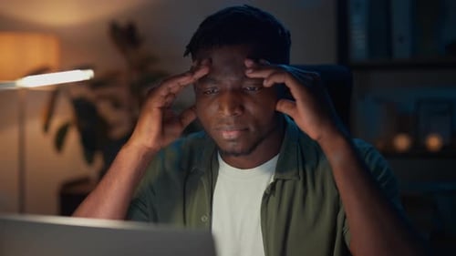 Man Working on Computer at Night