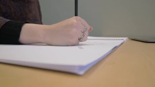 Young woman designing, sketching, drawing on a pad of paper