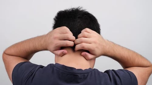 Man scratches his head