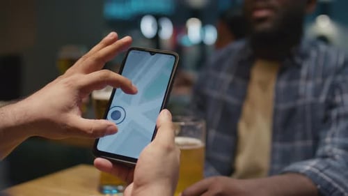People Using Map Application at Bar at Night