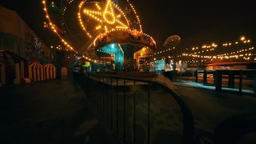 A Quiet Evening at an Empty Amusement Park with Bright Lights and Rides
