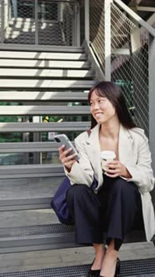 Businesswoman Drinking Coffee and Browsing Smartphone in Slow Motion