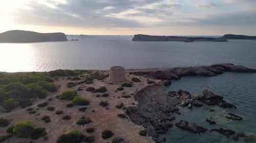 mediterranean coastal sunset ancient historic tower. Smooth aerial top view flight panorama orbit dr