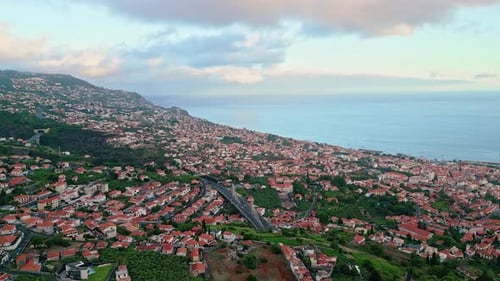 Drone View Coastal Town Nestled Mountain Slopes Under Cloudy Sky Scenic Village