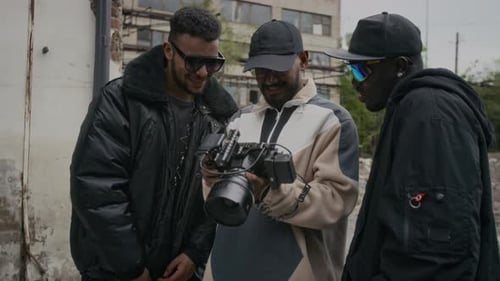 Three Young Adults Looking at Camera Display