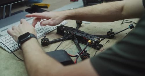 Hands Working on Internal Electronics Drone