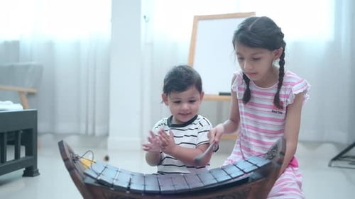 Children Playfully Making Music on Xylophone