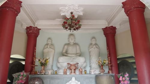 White marble Buddha Inside The Prayer Hall Of Temple In Vietnam. - tilt down