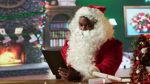 Santa Claus Using Tablet in Decorated Room