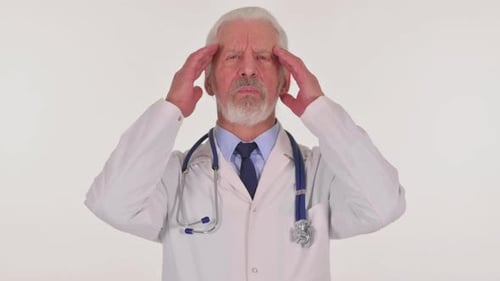 Senior Doctor Experiencing Headache in Studio Setting