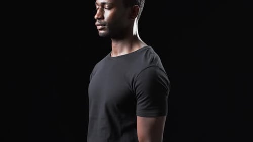 Man Wearing Black T-Shirt Looking to the Side
