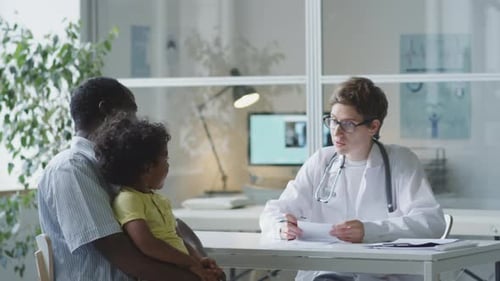 Doctor Consults with Parent and Child in Office