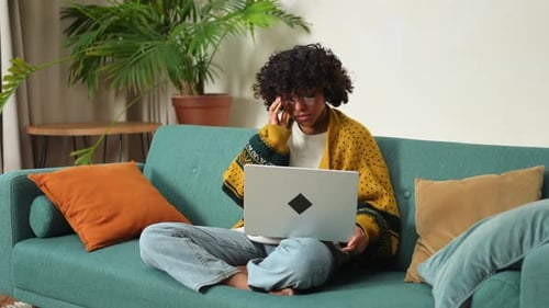 African American Girl Using Laptop at Home Office Looking at Screen Typing Chatting Reading Writing