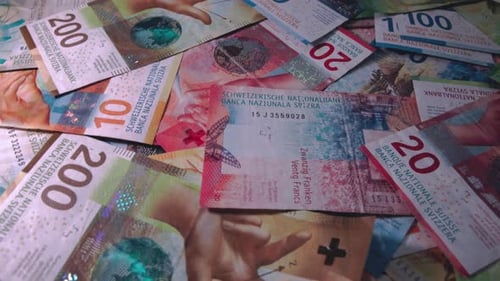 Pile of Colorful Swiss Franc Currency