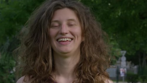 Woman with Curly Hair Laughs in Park