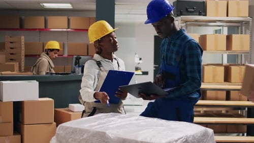 African American People in Overalls Analyzing Products