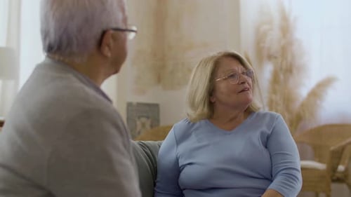 Elderly Couple Enjoying Conversation Together at Home