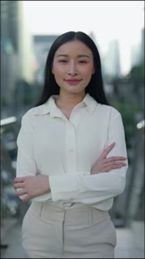 Vertical Video Portrait of the Attractive Female Office Worker Outside Standing Posing with Crossed