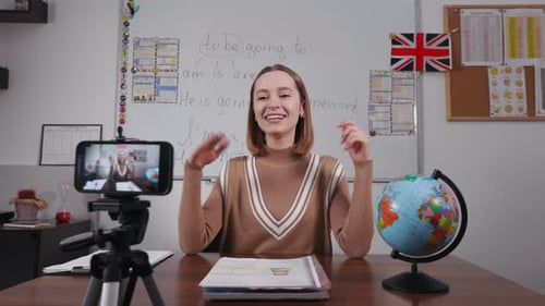 English Teacher Recording Video on Phone for Blog at School