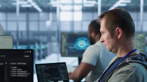 Programmer Requesting Help From Manager While Working on Computer in Data Center