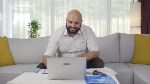 Home office worker man working on laptop.