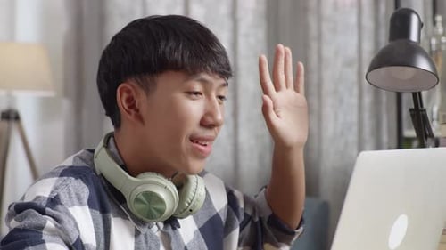 Young Adult Using Laptop and Video Conferencing