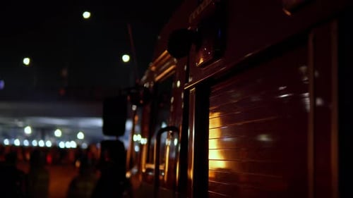 Fire Flames Reflected on Glossy Red Firetruck with Flashing Alarm Emergency Lights at Night Seoul, S