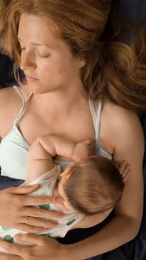 Mother and Baby Sleeping Peacefully Indoors