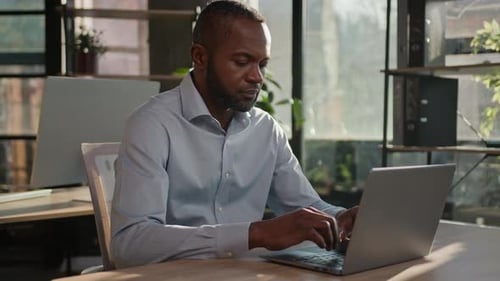 Man working on laptop in modern office