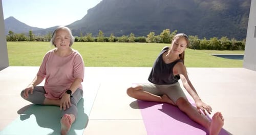 Women Stretching on Yoga Mats Outside