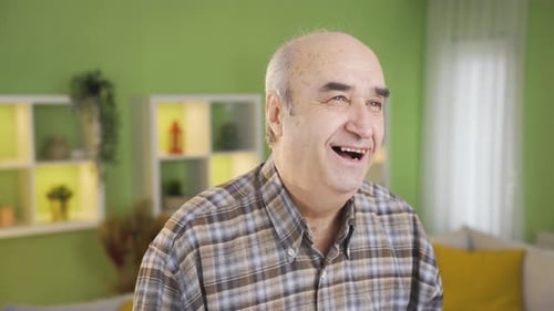 Delightful and happy old man laughing.